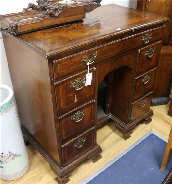 An early 18th century banded walnut kneehole desk W.95cm